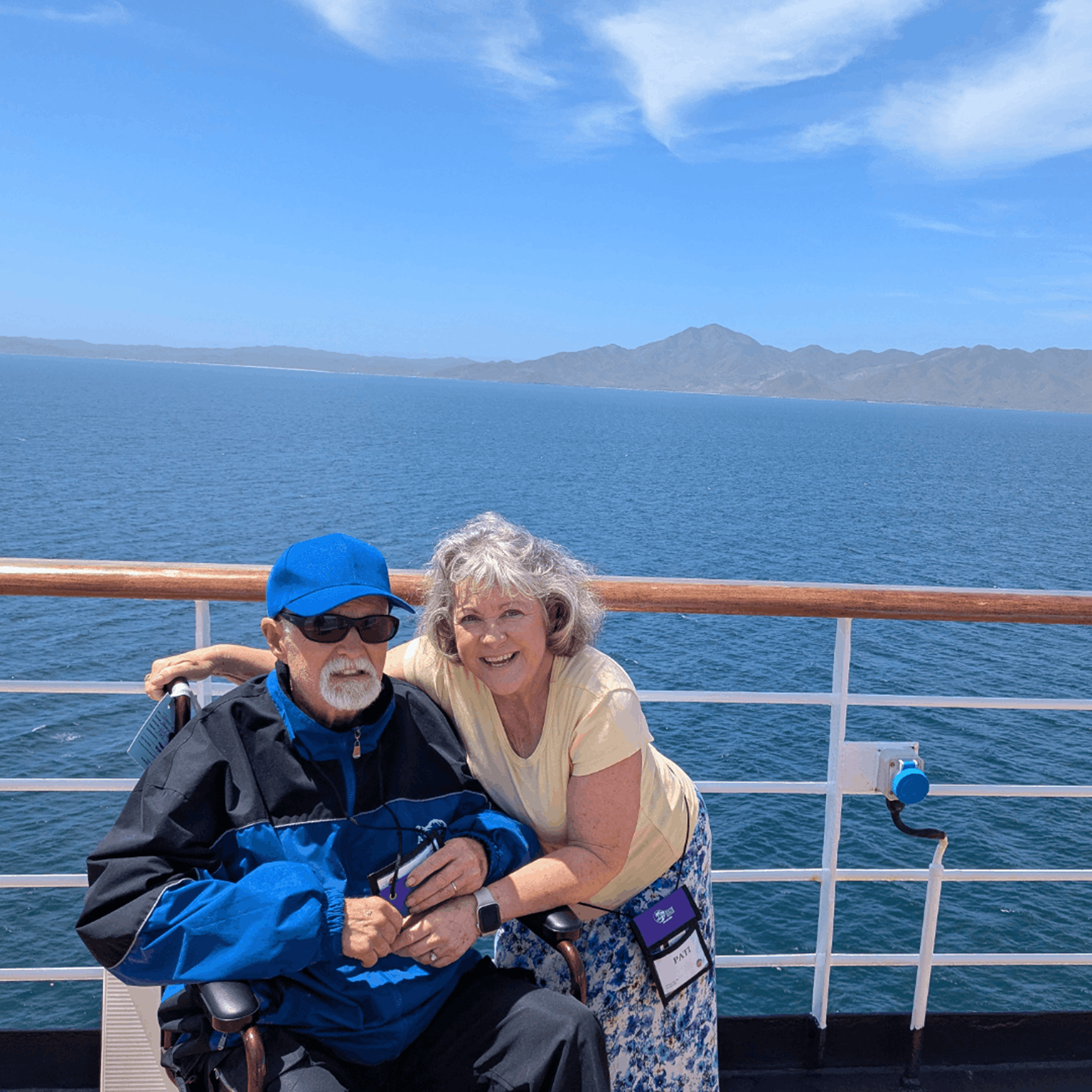 aSmiling older couple on a boat deck